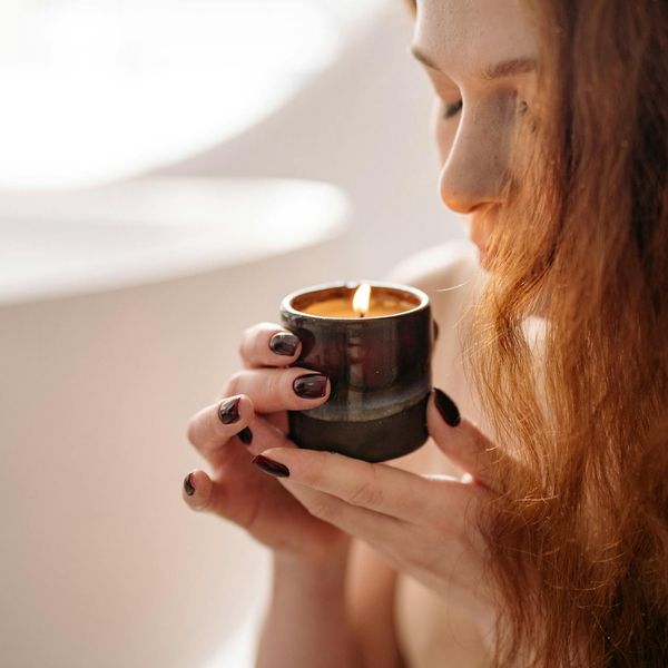 Person meditating peacefully with a soft amber light glow around them.